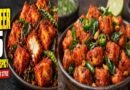Crispy restaurant-style Paneer 65 garnished with fried curry leaves, green chillies, and lemon wedges.